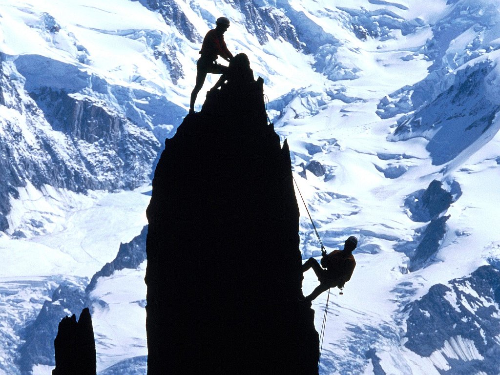 Rock Climbers Silhouetted by Mt. Blanc. France